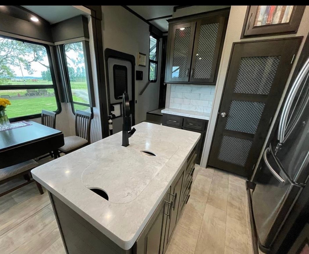 Kitchen and dining area with large windows and open floor plan