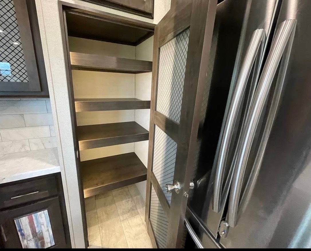 Full pantry with multiple shelves and organized storage space