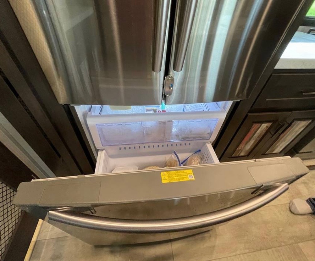 Residential refrigerator with bottom freezer drawer and stainless steel finish